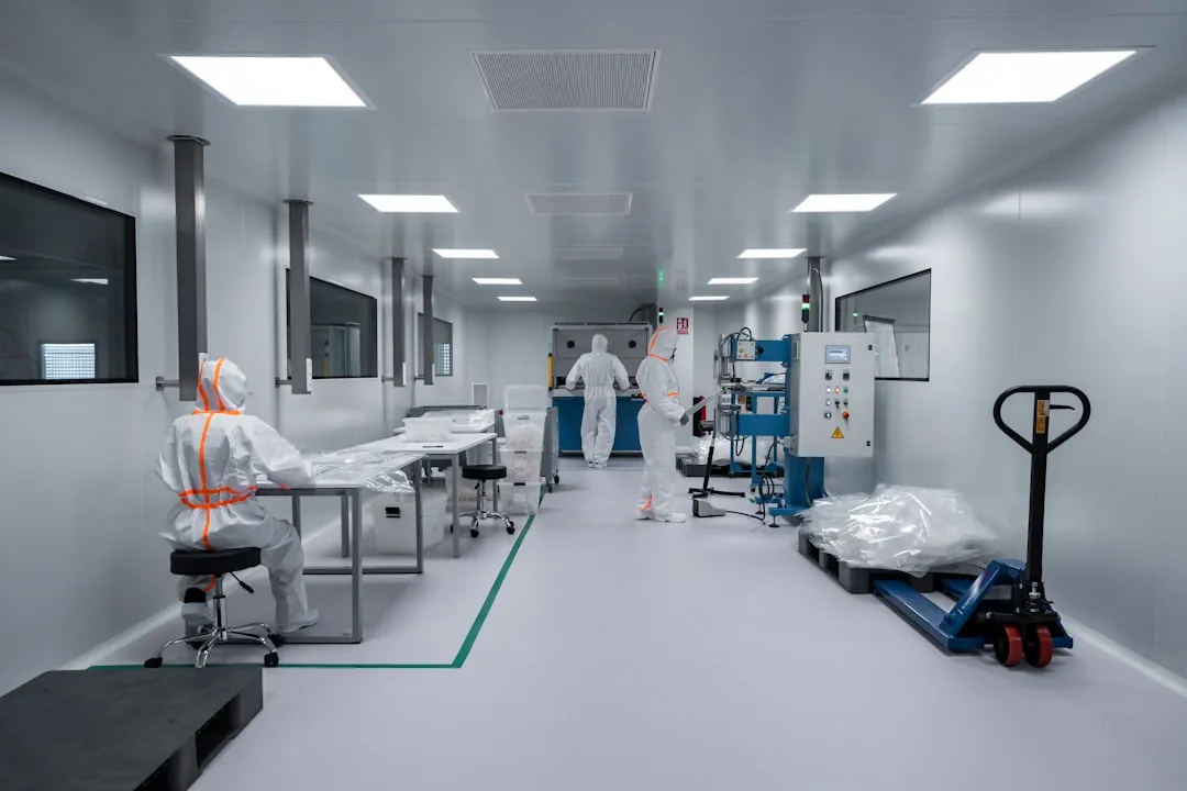 ISO 7 cleanroom production with operators in protective suits handling controlled materials